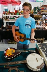 Cameron Irvine, 12, strums a baritone ukelele during the 36th annual Antique Sale and Flower Show on Wednesday, August 13, 2014 and wraps up Thursday from 10 a.m. to 5 p.m. at the Lakefield-Smith Community Centre. This year's show attracted about 34 antique dealers and over 250 floral exhibits organized by the Lakefield and District Horticultural Society, a non-profit group that raises funds through its annual antique and flower sale o beautify the village of Lakefield. Admission to the show is $5 and children 12 and under are free when accompanied by an adult. Clifford Skarstedt/Peterborough Examiner/QMI Agency — at Lakefield Horticultural Society.